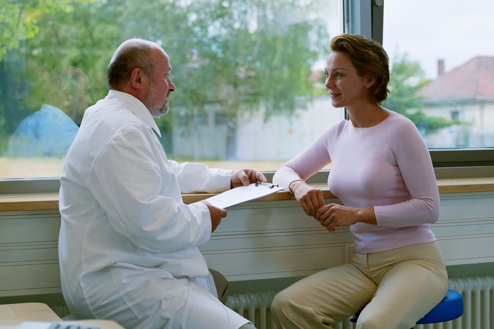 woman consulting with doctor - Pacifica Center For Plastic Surgery woman consulting with doctor