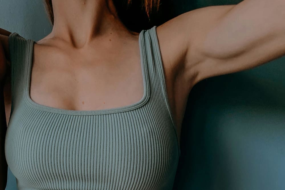 woman in blue tank top - Pacifica Center For Plastic Surgery woman in blue tank top